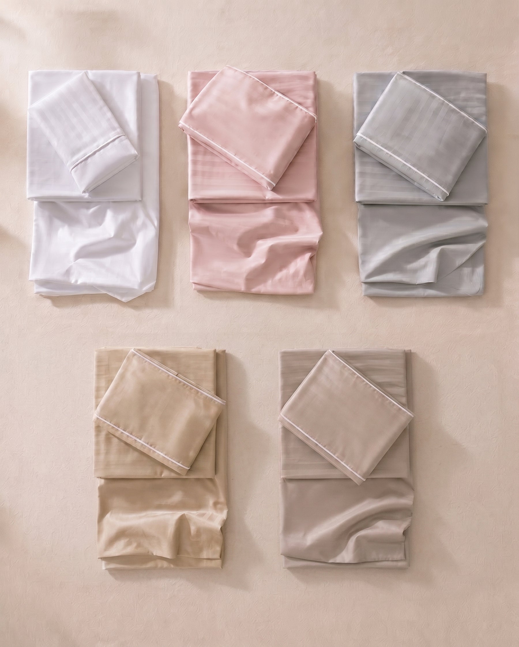 Los cinco tonos del juego de sábanas: blanco, palo de rosa, gris, camel y beige